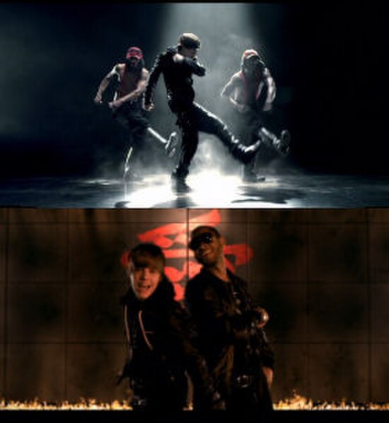 Bieber performing jerkin'-esque choreography with dancers and in a scene with a calligraphy backdrop and flame outline with Usher