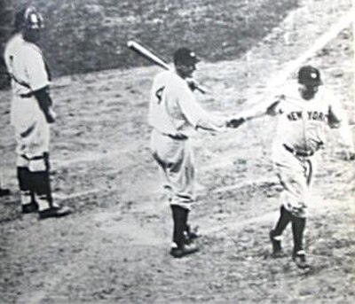 Ruth is congratulated by Gehrig after hitting his "called shot." Gabby Hartnett, the Cubs catcher, watches.