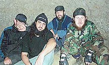 A photo of Al-Hattab (second from left) and Gochiyayev (second from right). The photo was allegedly fabricated by the FSB to prove the guilt by Gochiyaev Gochiyayev and Hattab according to FSB.jpg