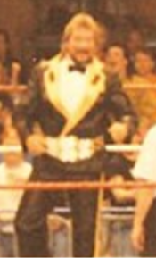 The first champion, "The Million Dollar Man" Ted DiBiase. According to the storyline, he created the title when he was unable to win the WWF Championship Million $ Champion.png