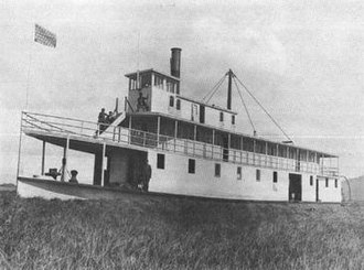 Winema on the failed attempt to navigate the Wood River, May 1905, surrounded by a "sea of grass". Winema on Wood River May 1905.jpg