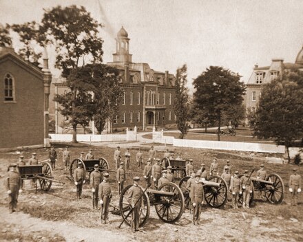 WVU's Cadet Corps, c. 1880, from the site of where Oglebay Hall is today, Martin Hall (center) and Woodburn Hall (right) are in the background.
