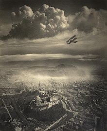 An aerial photo of Edinburgh with an aeroplane visible