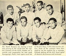 North Korean Propaganda Photograph of prisoners of USS Pueblo. Photo and explanation from the Time article that exposed the Hawaiian Good Luck Sign secret. The sailors were flipping the middle finger, as a way to covertly protest their captivity in North Korea, and the propaganda on their treatment and guilt. The North Koreans for months photographed them without knowing the real meaning of flipping the middle finger, while the sailors explained that the sign meant good luck in Hawaii. North Korea Propaganda Photograph of prisoners of the USS Pueblo, with the Hawaiian Good Luck Sign, 1968.jpg
