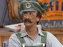 Wells playing his role as the first live-action Luigi from The Super Mario Bros. Super Show!.