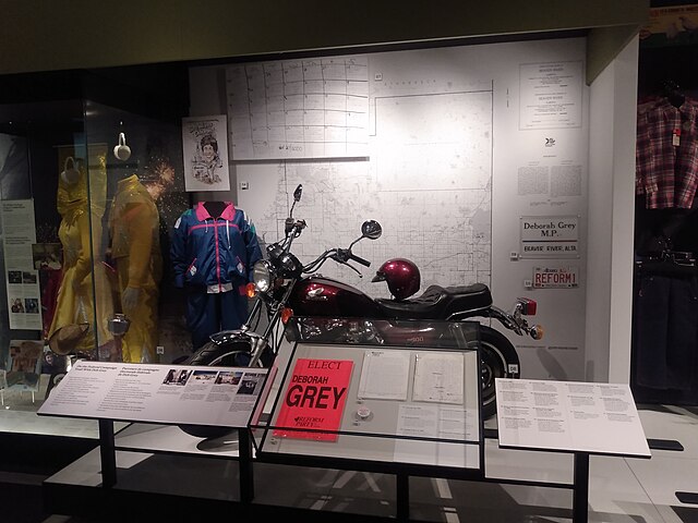 A display at the Royal Alberta Museum depicts artifacts from her campaign in the 1989 by-election, including her motorcycle