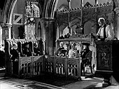 Scene showing Alec Guinness in six of the roles he portrayed (second from the left is Valerie Hobson as the recently widowed Edith). The cinematographer Douglas Slocombe masked the lens and filmed over several days to achieve the shot. Alec Guinness in Kind Hearts and Coronets.jpg