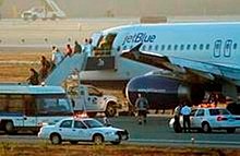 Passengers deplane by application of airport stairs vehicle Jetblue Flight 292.jpg