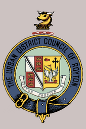 The coat of arms of the former Royton Urban District Council.[33]