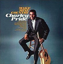 Charley Pride, holding a guitar