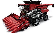 Case IH 7140 rotary harvester with corn header with cutaway showing rotary threshing mechanism Case IH 7140 rotary harvester with corn front with cutaway showing rotary threshing mechanism.jpg