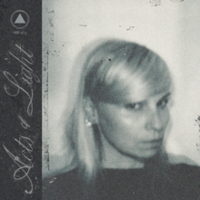 A blurry black-and-white photo of Hilary Woods, with the album title in cursive in a sidebar