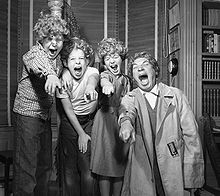 Marx and three of his children wearing Harpo wigs in Los Angeles, 1954