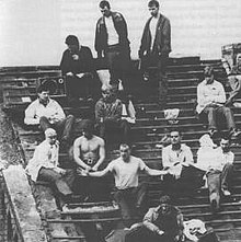 Prisoners protesting on the badly damaged roof of the prison. Paul Taylor is in the centre with his arms outstretched. Strangeways riot rooftop.jpg