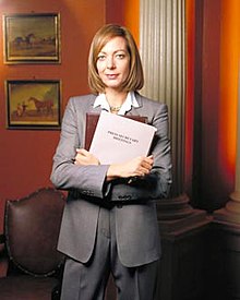 Allison Janney, pictured in costume as C. J. Cregg, for a promotional shoot