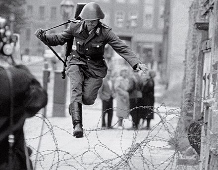 NVA soldier Conrad Schumann defecting to West Berlin during the Wall's early days in 1961.