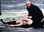 Father [[Alec Reid]] administers the last rites to Corporal David Howes.