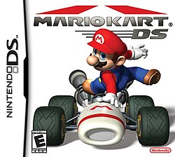 Video game box art. A video game character, Mario, leaps over a racing kart.