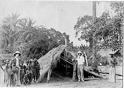 Donald Dron and William Kirby outside last surviving fetish temple. Yalemba, Congo, c 1902.