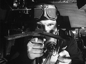 A bomb aimer prepares to drop his bouncing bomb using an improvised device to determine the correct distance from the dam. Dam Busters bombadier.jpg