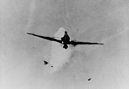 The Mitsubishi A6M Zero kamikaze moments before it struck Columbia's antennae on 6 January. Note fragments of the plane falling off as the ship's anti-aircraft guns attempted to shoot it down