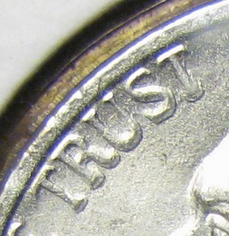 DDD on a 1999 P Jefferson nickel. Note the extended and irregular forms around the lettering. DDD closeup.jpg