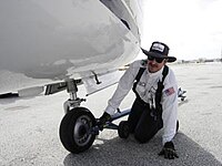 A line tech attaches a tow bar to a small private jet Linetech4.jpg