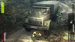 Snake and an MSF soldier conducting a Co-Ops mission. The image has Snake in Naked uniform hiding from a Peace Sentinels soldier, armed with an M60 GPMG. The player's partner is barely seen hiding on the other side of the truck. MGS Peacewalker screenshot.jpg