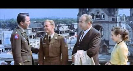 Peck, Ted Avery, Crawford, Marianne Koch shown in front of the Kaiser Wilhelm Memorial Church in the American Sector of Occupied Berlin (R2 DVD Cinema
