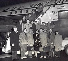 The New Glenn Miller Orchestra, with vocalist Lorry Peters flanked by Hambro and Ray McKinley, boarding a flight to Europe in 1957.