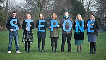 Staff helping to launch the charity's new name Staff from Step One holding up the charity's name.jpg