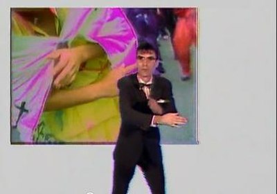 In the "Once in a Lifetime" music video, singer David Byrne, dressed in a suit, bowtie and glasses, dances erratically over footage of religious ritua