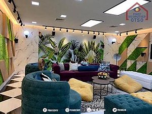 The living room area of the Pinoy Big Brother House used for the Otso season. As shown, the one-way wall mirrors were removed and were replaced by robotic cameras as seen in the top left and top right sections of this photo. The furnitures, however, were replaced during the middle of the season to accommodate the entry of the other batches.