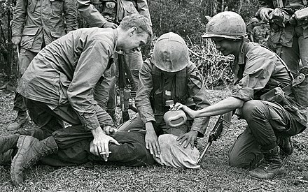 Two United States soldiers and one South Vietnamese soldier waterboard a captured North Vietnamese prisoner of war near Da Nang, 1968.