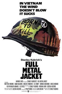 Against a white backdrop is a camouflaged military helmet with "Born to Kill" written on it, a peace sign attached to it, and a row of bullets lined up inside the helmet strap. Above the helmet are the words, "In Vietnam the wind doesn't blow it sucks."