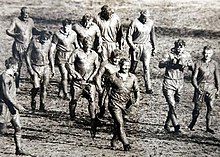 Unrecognizable after playing on a muddy SCG, footballers of the British and Australian national rugby league sides leave the field after the first Test on 12 June 1950. SCG rugby league match 1950.JPG