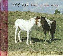 A photo of two horses in a field with the album named scrawled on top