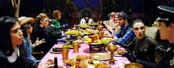 Jessie J sitting in a feast table referencing the Mad Hatters' tea party. Nobody's Perfect musicvideo.jpg