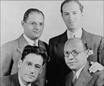 Bottom, left to right: [[George S. Kaufman]], Morrie Ryskind, (top) [[Ira Gershwin]], [[George Gershwin]]