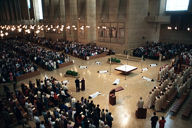 White-clad deacon candidates prostrate before the altar of the Cathedral of Our Lady of the Angels in Los Angeles during their ordination liturgy