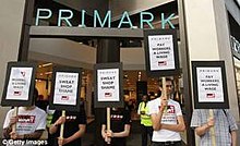 Protesters stand outside the Primark shop on Oxford St with SWEATSHOP SHAME banner Portestorr.jpg