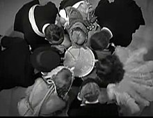 Revelers drink champagne from a tureen with straws. The Production Code Administration urged Universal to curtail the amount of drinking in the film. Soupson.jpg