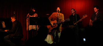 Karaban at the Hotel Cafe in Los Angeles with Lucy Schwartz, and members of Elvis Costello's band The Imposters and Counting Crows Karaban w Imposters.png