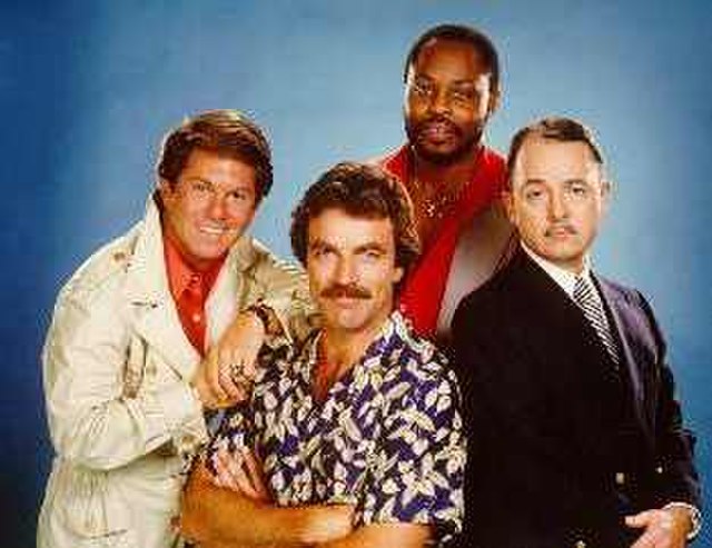The cast of Magnum, P.I. (left-to-right), Larry Manetti as Rick, Tom Selleck as Magnum, Roger E. Mosley as T.C., and John Hillerman as Higgins