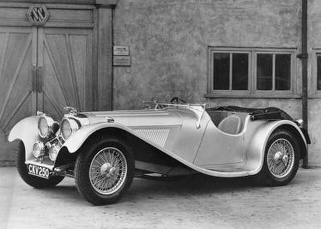 A publicity shot of CKV250 outside the SS Cars building in 1937. This is considered to be the first recorded use of the Jaguar 'leaper' mascot.