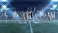 Burke and her female backing dancers dressed in gold leotards with football-style shoulder pads and heeled shoes, perform the outdoor dance sequence of the video. The scenes are intercut with shots of the group changing and Burke in a green-lit tunnel.