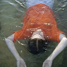 A photo of a woman lying under water