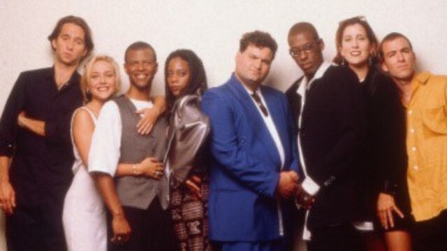 The inaugural 1995 cast of Mad TV, from left to right: David Herman, Nicole Sullivan, Phil LaMarr, Debra Wilson, Artie Lange, Orlando Jones, Mary Sche