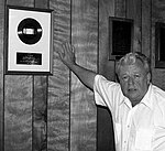 Miller with a gold record awarded to Kitty Wells