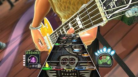 To play the game, players must use a guitar peripheral to play the scrolling notes. Players must hold a colored fret on the peripheral corresponding t